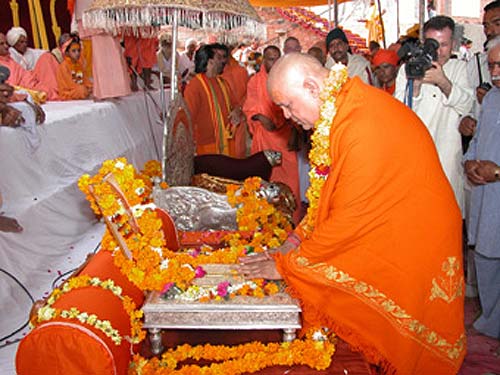 Swamiji is greeting the sandals (holy feet) of Holy Guruji